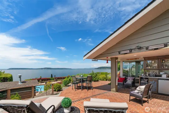 Outdoor living area with built-in wet bar, dining and lounge seating, and uninterrupted Puget Sound views — designed for entertaining in any season. Outdoor living area with built-in wet bar, dining and lounge seating, and uninterrupted Puget Sound views — designed for entertaining in any season.