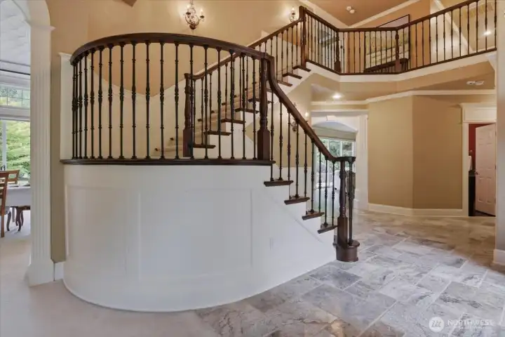 Grand staircase, entry, tile, soaring ceilings, custom woodwork Grand staircase, entry, tile, soaring ceilings, custom woodwork