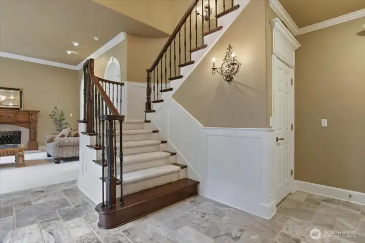 Grand staircase, tile floor, entrance, soaring ceilings, foyer, sconces, custom woodwork Grand staircase, tile floor, entrance, soaring ceilings, foyer, sconces, custom woodwork