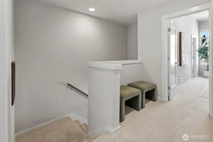 Upper-level landing provides separation between bedrooms and convenient access to laundry and storage. Upper-level landing provides separation between bedrooms and convenient access to laundry and storage.