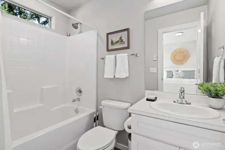Full guest bath conveniently located adjacent to the secondary bedroom - a dual primary setup. Full guest bath conveniently located adjacent to the secondary bedroom - a dual primary setup.