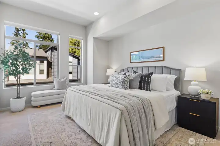 Generous primary suite with soaring ceilings, oversized windows, and abundant natural light. Generous primary suite with soaring ceilings, oversized windows, and abundant natural light.