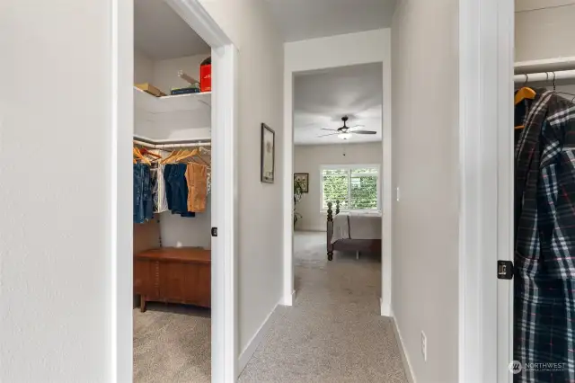 Separate his and her walk-in closets finished with shelving and rods.