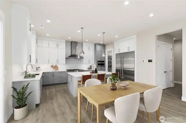 Breakfast area looking towards kitchen.  Full height tile backsplash and modern kitchen pendant lights.  Virtual staging of actual home!