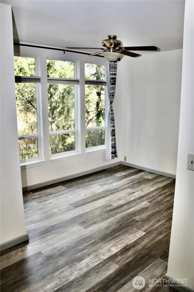 These Floors - looking into the dining room space with large windows overlooking a beautiful landscape