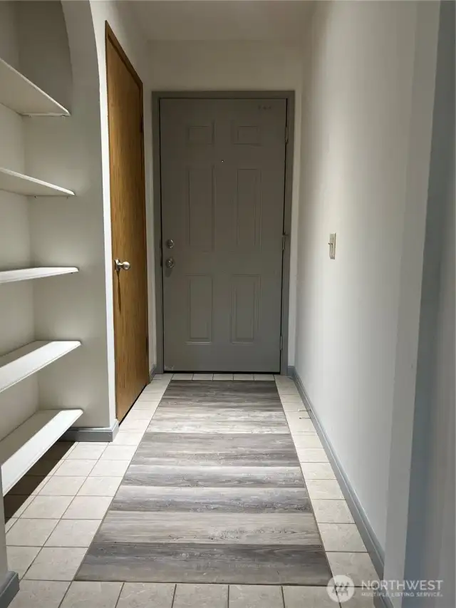 Entry way is spacious with a built in book shelf