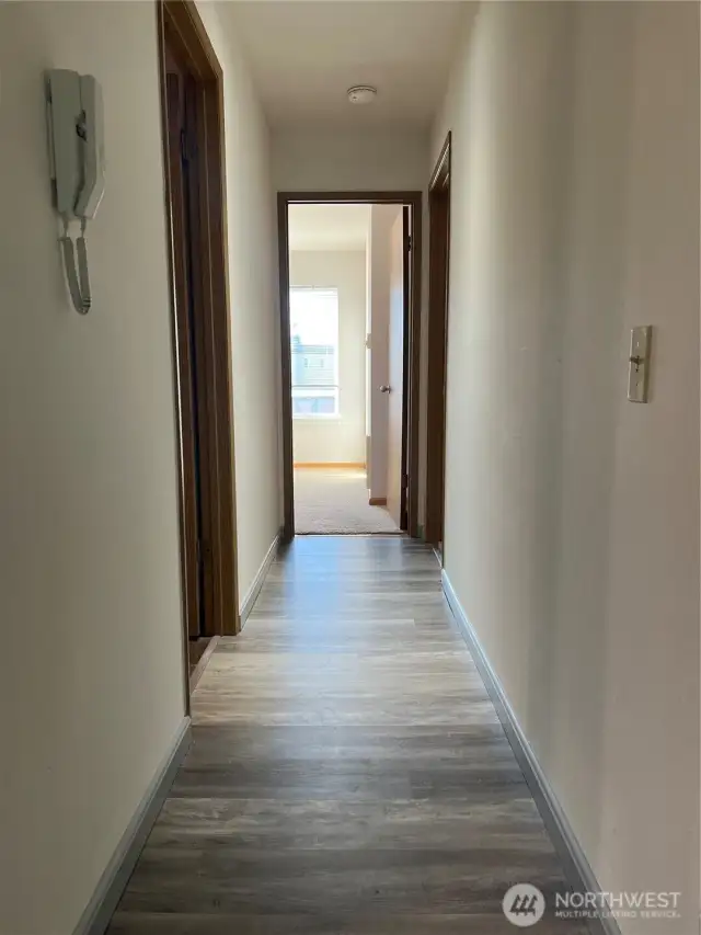 The hallway from living room space headed to the 2 beds and 1/75 baths