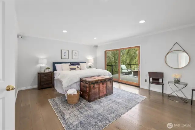 Beautiful primary suite with access to private deck overlooking the backyard.