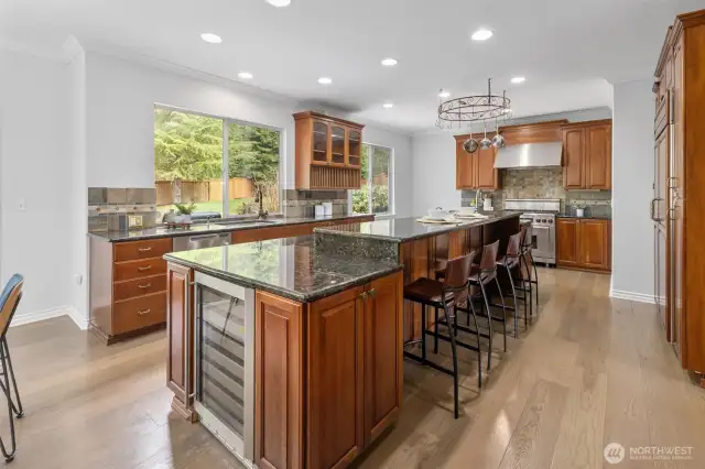 This kitchen has it all ... huge center island with eating space, dual dishwasher, and wine fridge.