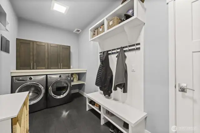 Utility room connects the 3 car garage to the home.