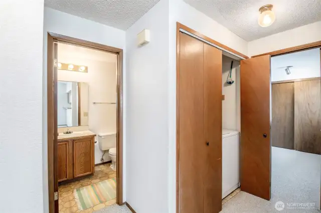 Main bathroom, closet with Washer/dryer in hallway.