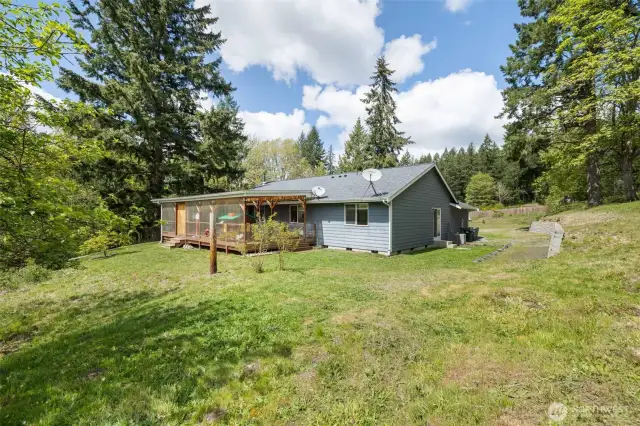 View of the back of the house with the massive 16x33, fully enclosed deck.