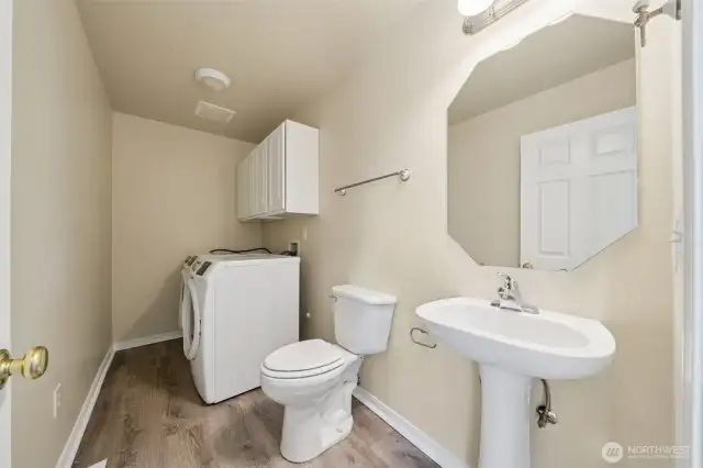 Main floor half bath and utility room.