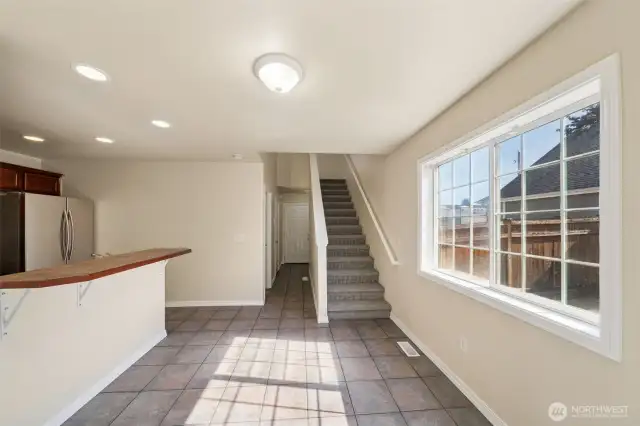Living room looking back towards kitchen, entry and stairs to 2nd level.