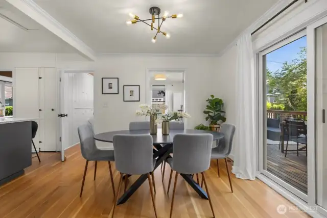 Sliders in dining room out to large deck and back yard