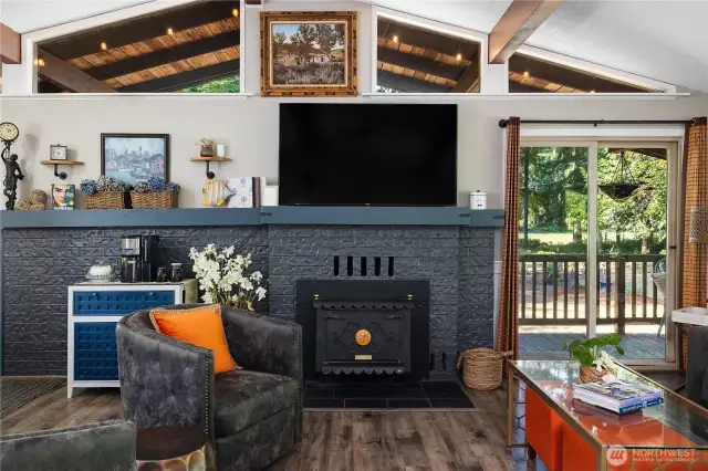 Charming brick fireplace bordered by sliding glass doors.