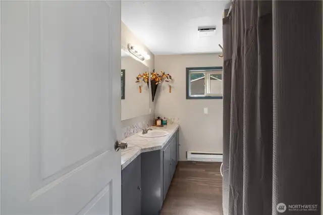 Looking in the full bath, storage behind the door too.