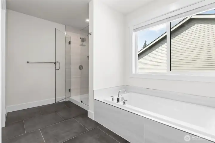 Frameless glass shower and large soaking tub