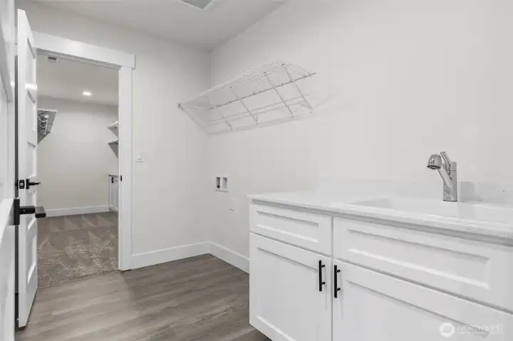 Quick access from primary to laundry room with sink