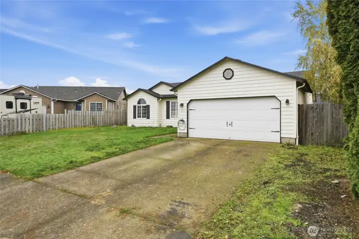 Front of house with driveway and garage- street view