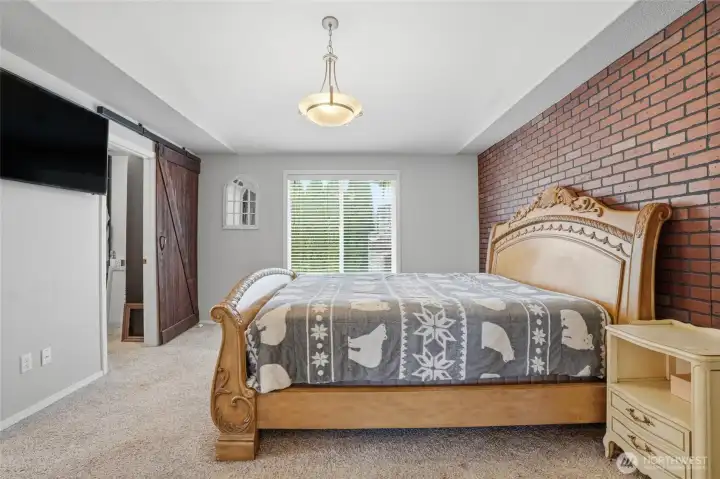 Primary bedroom with barn doors to walk-in closet