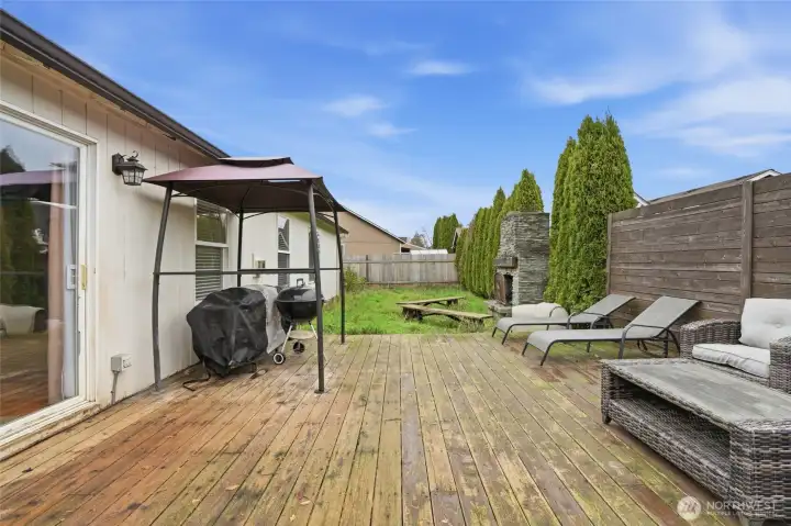 Fenced backyard with deck