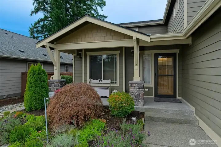Covered front porch and storm door with a screen.