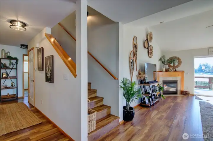 Hallway to prime bedroom, guest half bath, laundry room and garage.