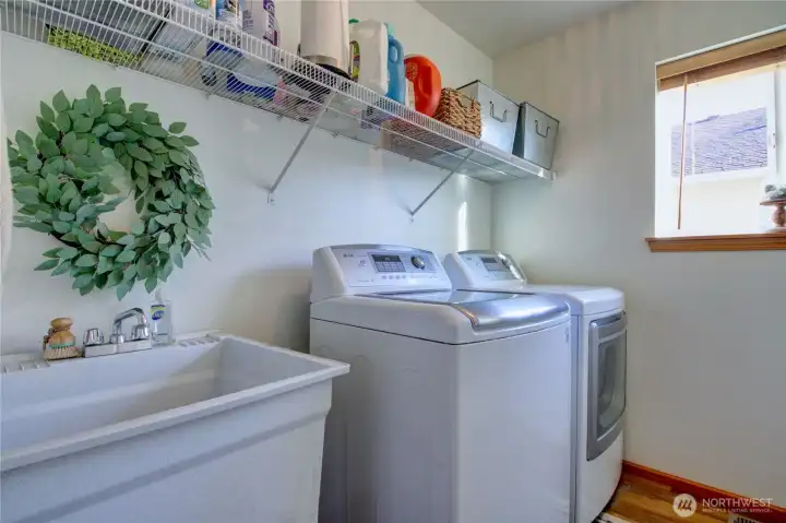 Laundry room with washer/dryer and deep sink.