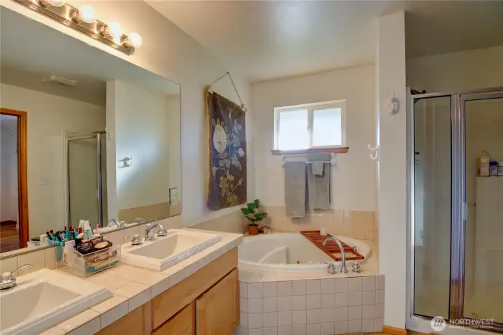 Primary ensuite bathroom. Jetted tub and double sink vanity. Walk in closet is attached to bathroom