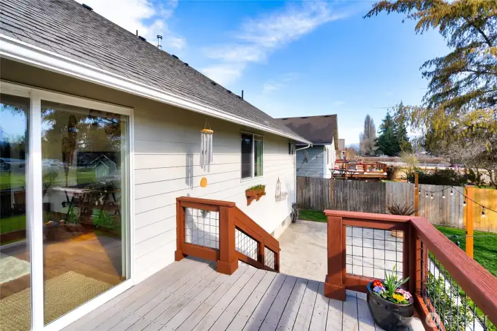 Deck with stairs down to patio and back yard