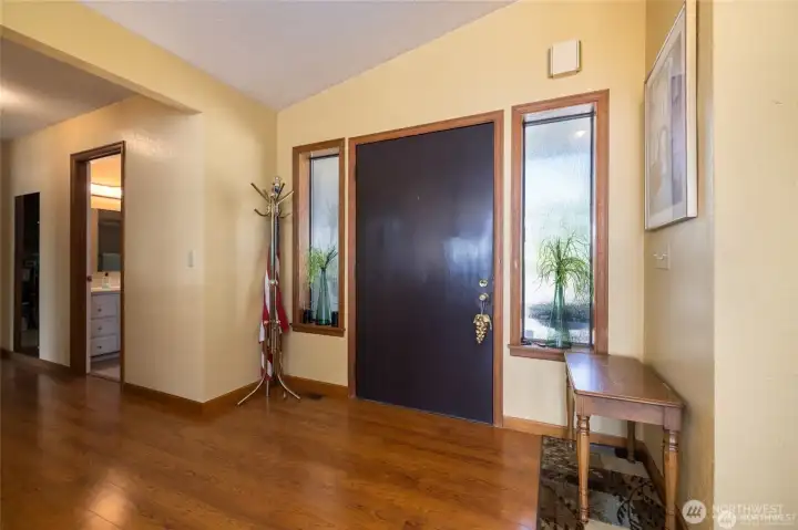 Front hall towards full bath, primary bedroom, utility room and garage entrance...