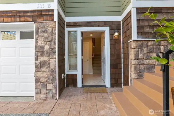 Front entrance, adjacent garage, and stone detailing.