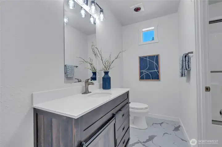 Shared Jack and Jill bathroom featuring a convenient pass-through tub/shower.