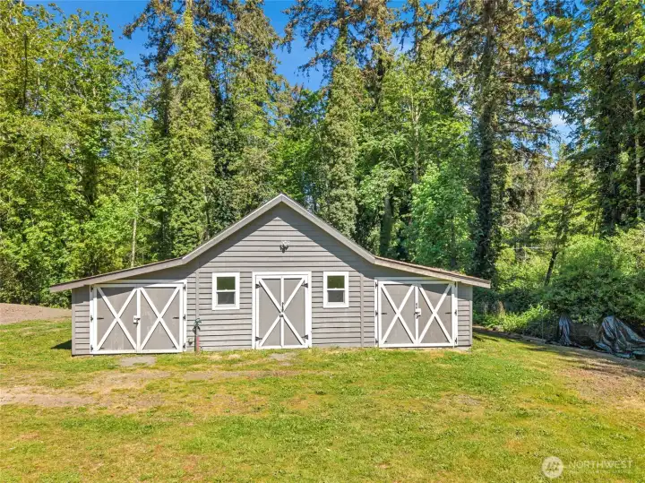 Detached well house with abundant storage and shop potential.