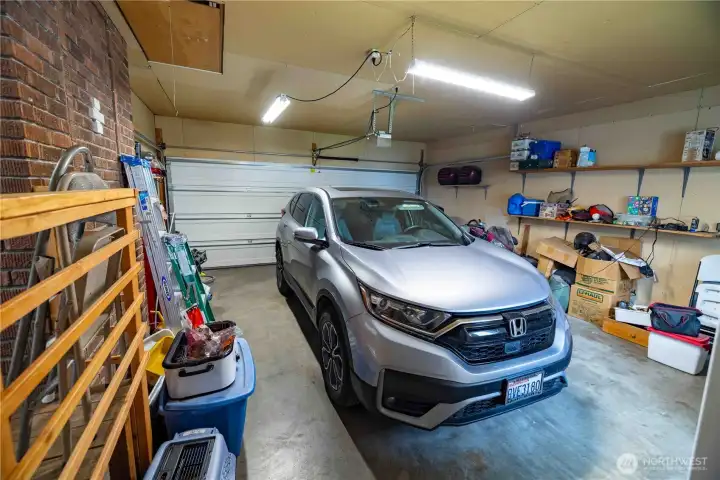 attached garage with a car in