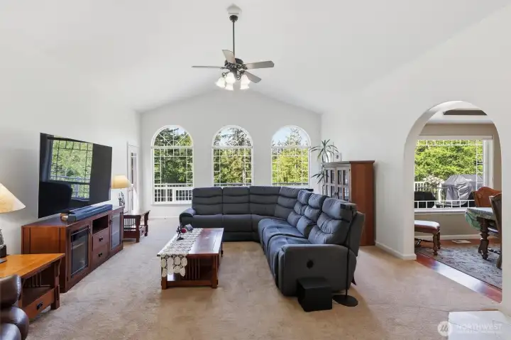 Spacious living room boasts lots of natural light with multiple windows to take in the beauty outside.