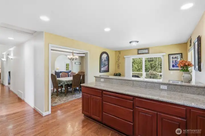 French glass doors separate the kitchen and formal dining.