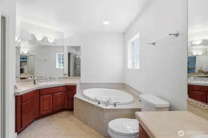 Double vanities, soaking tub, and seamless shower.