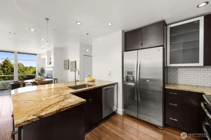 Sleek stainless steel finishes and a spacious modern refrigerator make this kitchen as functional as it is stylish Sleek stainless steel finishes and a spacious modern refrigerator make this kitchen as functional as it is stylish