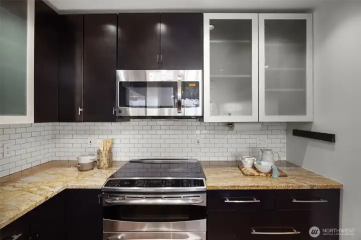 Premium stainless steel appliances, including a GE Profile double oven and a built-in wine fridge