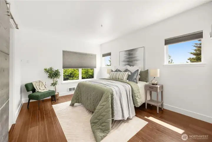 Generous primary retreat with great natural light and a stylish modern barn door entry.