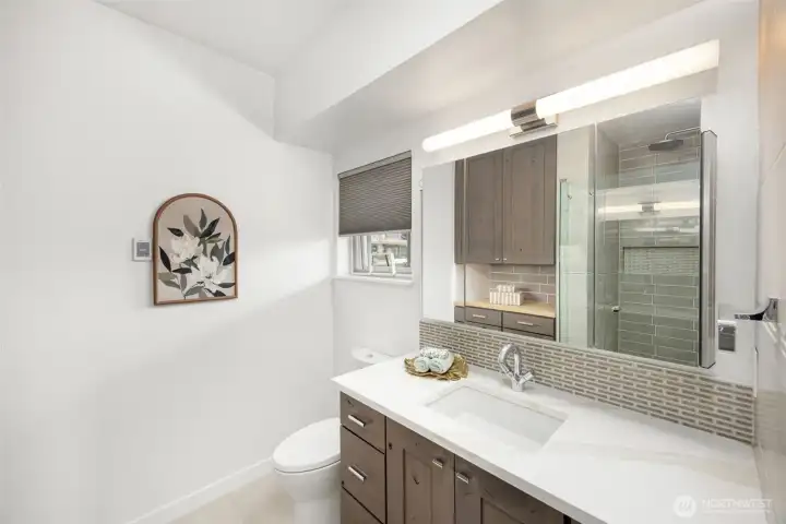 Full primary ensuite boasting custom vanities and extensive built-in drawer storage