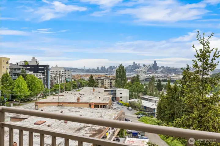 Massive resident rooftop deck with panoramic views of the Seattle skyline and Cascades