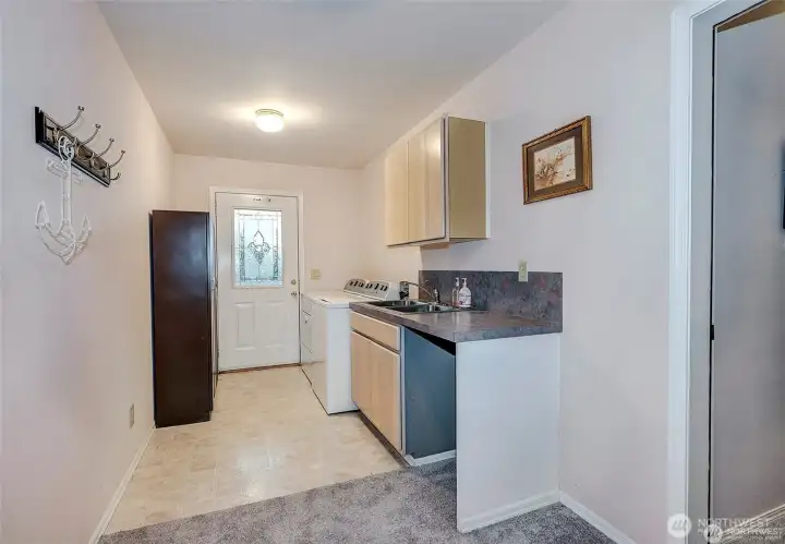 Downstairs Utility Room w/Washer/Dryer, Sink, And 2 Car Garage Access.