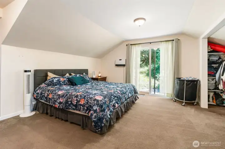 Primary bedroom on upper level has sliding doors going outside Primary bedroom on upper level has sliding doors going outside