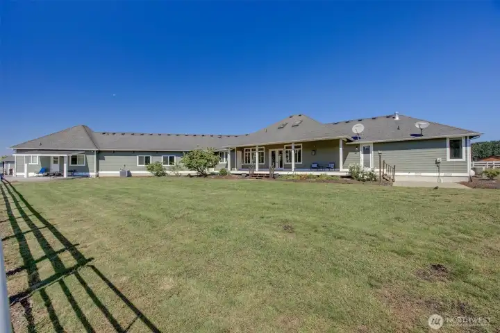 Back of the home and Large Yard. Left is Covered ADU Private Patio. Middle is 3 Car Garage. Then Relaxing Deck with entry to the Formal Dining and Living Room. Then the Primary Suite with Deck Access!