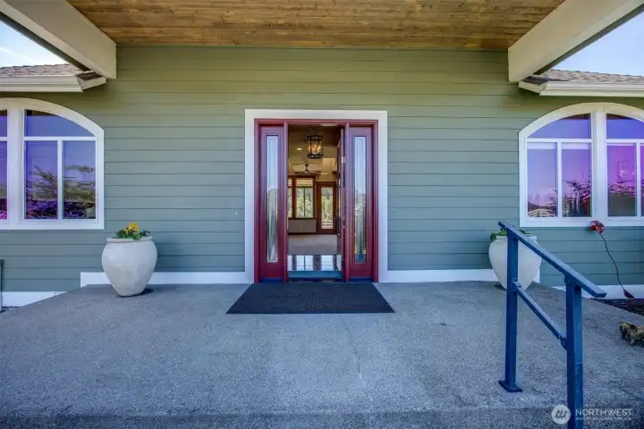 Brand new Statement Entry Door.  Covered Porch, room enough for plants or a couple of chairs! To the left of the picture (not shown) is a Rock Water Feature.