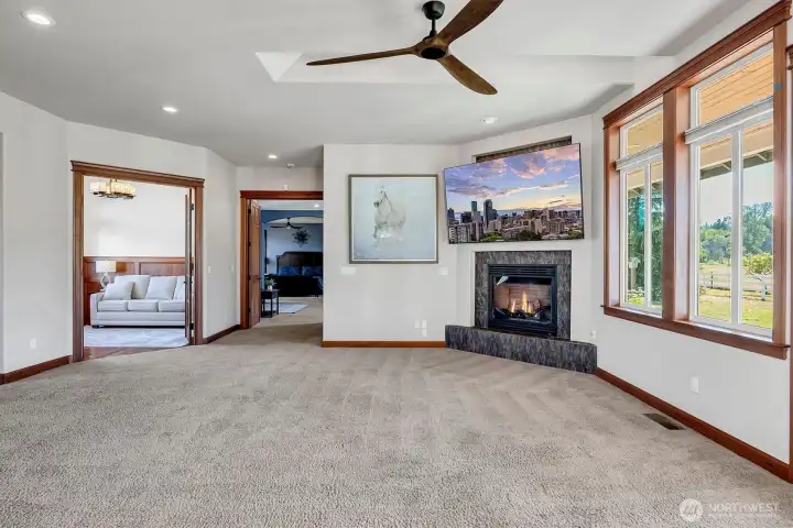 This picture does not show how large the Living Room is. Gas Fireplace, 2 Large Skylights and Ceiling fan keep the room comfortable. Large Wood Wrapped Windows. The Home office is on the Left and the Fantastic Primary Suite is down the hall with double doors for privacy!