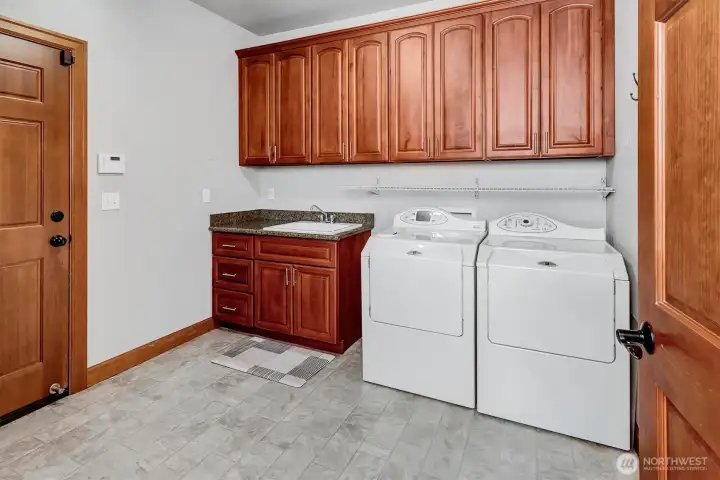 Lots of Storage and room to add a folding table to the left of the door that leads to the roomy 3 Car Garage!